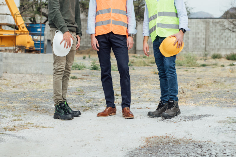 three working people wearing Proxons on a construction site.