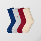 Ah pack of four pair of socks. Each one has a different color. Blue socks. Grey socks. Red socks. Creamy socks