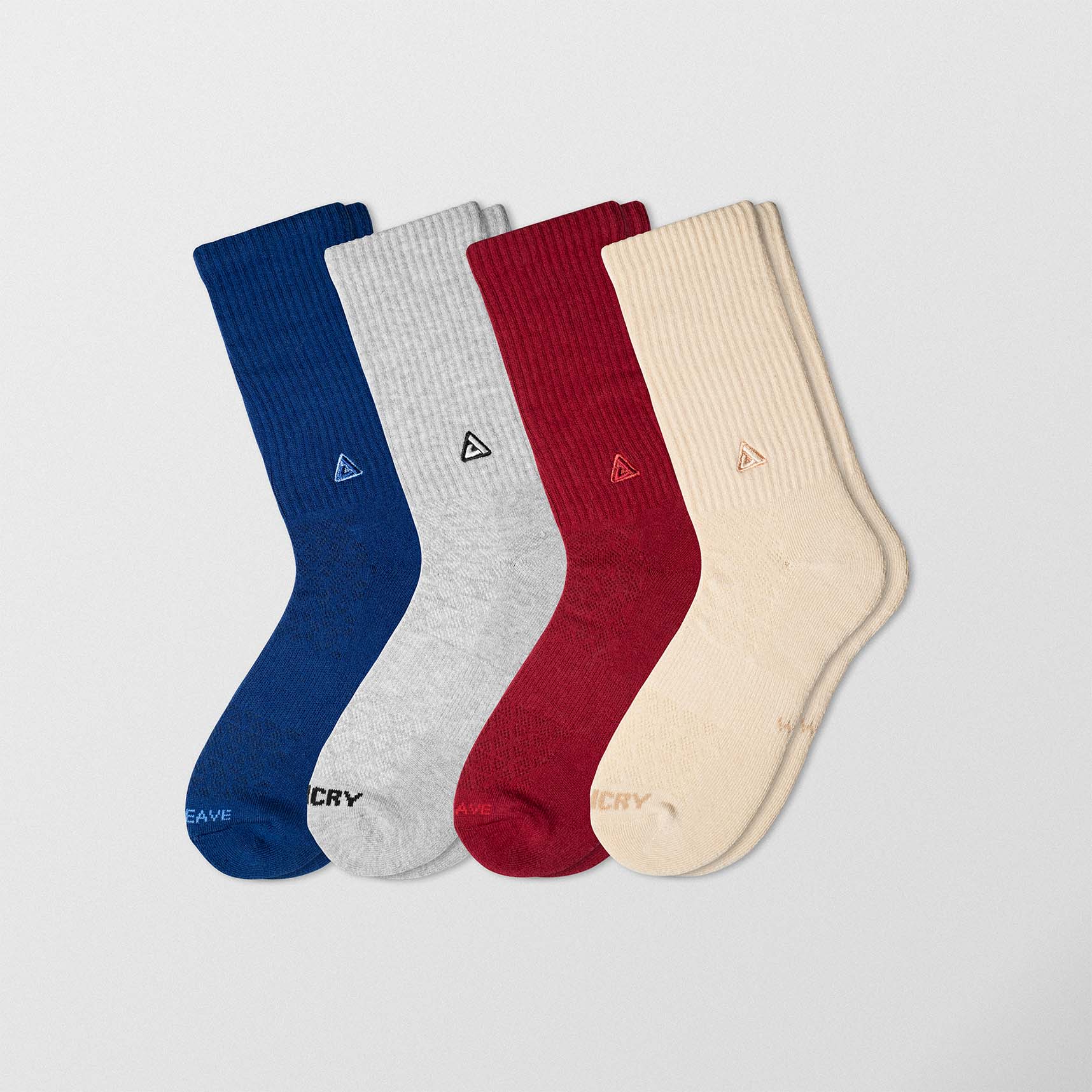 Ah pack of four pair of socks. Each one has a different color. Blue socks. Grey socks. Red socks. Creamy socks